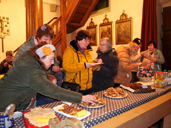 Blick auf das Essen und die Getränke. Einige Frauen schauen sich die Sachen an.